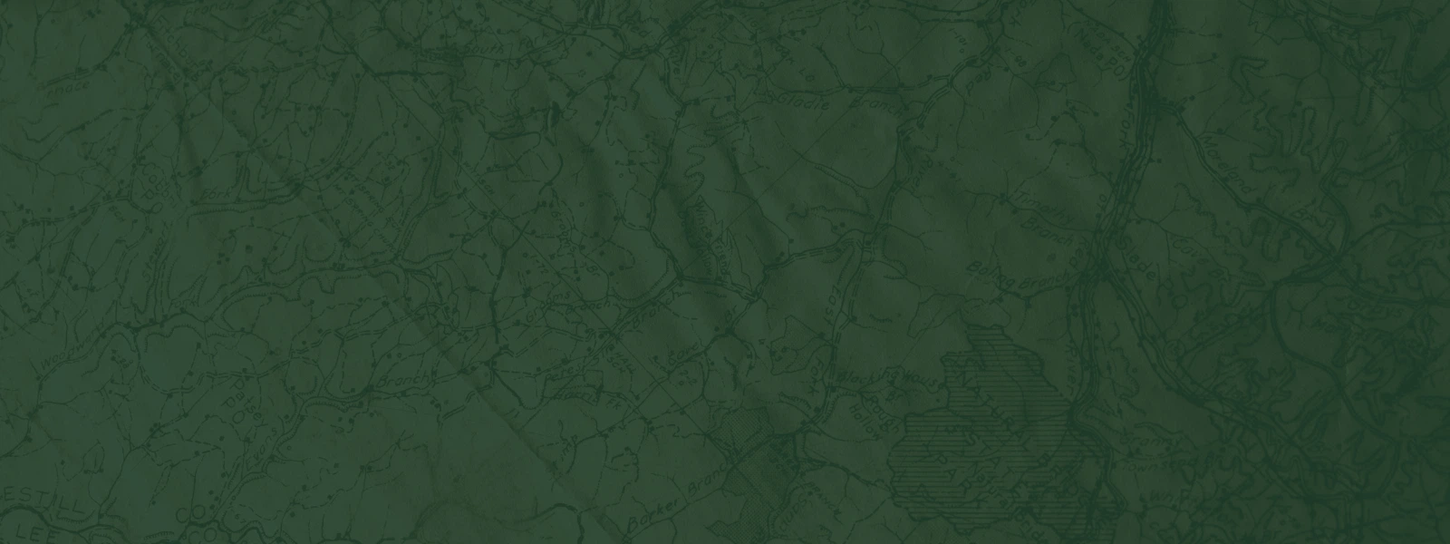 closeup photo of an antique map beneath a forest green overlay (Discover phase)
