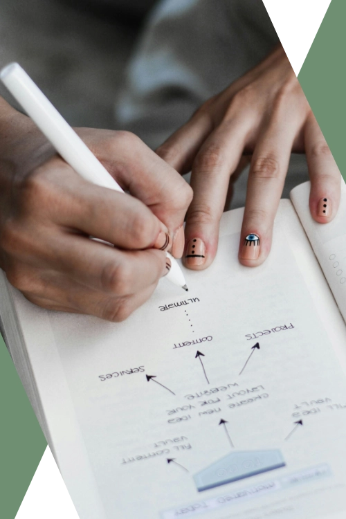 close-up photo of a woman with painted nails working on a marketing plan in a notebook (featured image: "Marketing Execution Support" section of Caesura Strategy's Small Business Consulting Services page)