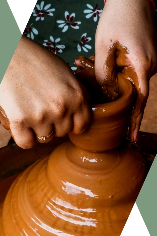 close-up photo of a woman's hands as she works a rich orange clay pot (featured image: "Accountability Partnership + Business Coaching" section of the Caesura Strategy Small Business Services page)